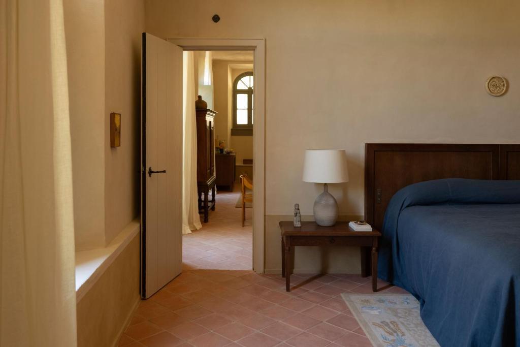 a bedroom with a bed and a table with a lamp at Hôtel du Couvent, a Luxury Collection Hotel, Nice in Nice