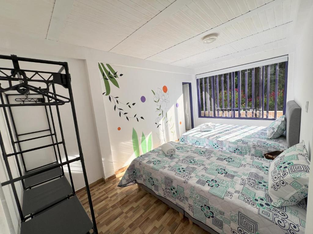 Postel nebo postele na pokoji v ubytování NUEVO Hotel Morada en el centro del Eje Cafetero