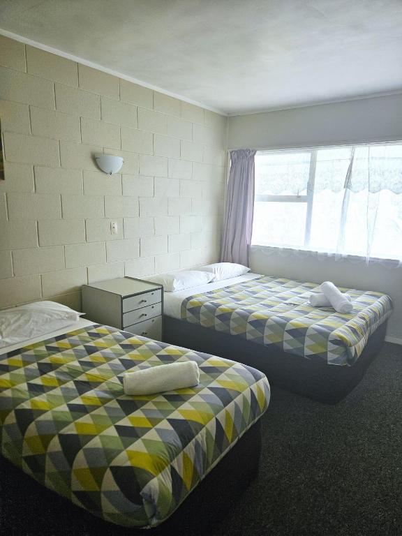 Postel nebo postele na pokoji v ubytování Takanini Park Motor Lodge