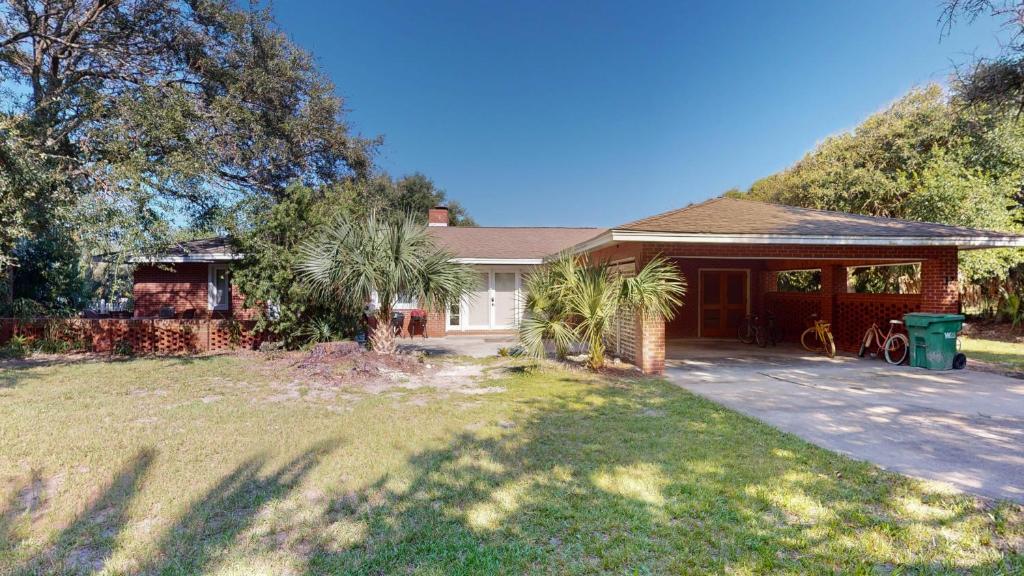 a house with a yard with a driveway at ALWAYS TURTLE CRAWL home in Jekyll Island