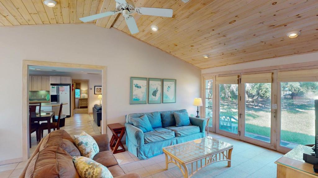 a living room with a couch and a table at ALWAYS TURTLE CRAWL home in Jekyll Island
