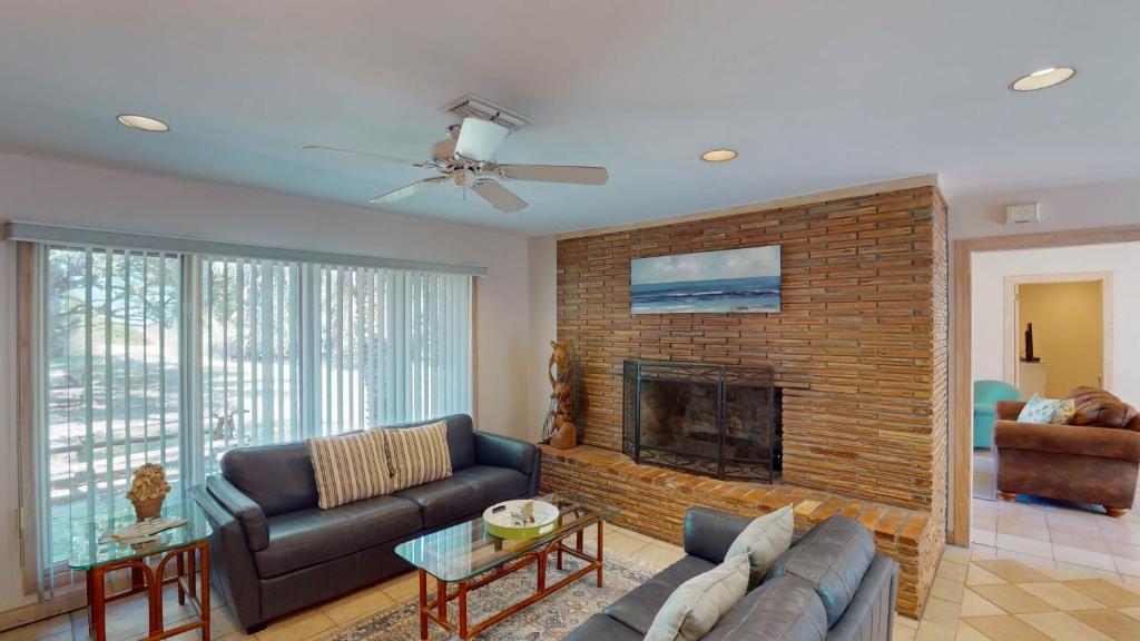 a living room with a couch and a fireplace at ALWAYS TURTLE CRAWL home in Jekyll Island