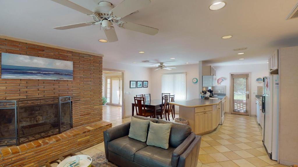 a living room with a fireplace and a couch at ALWAYS TURTLE CRAWL home in Jekyll Island
