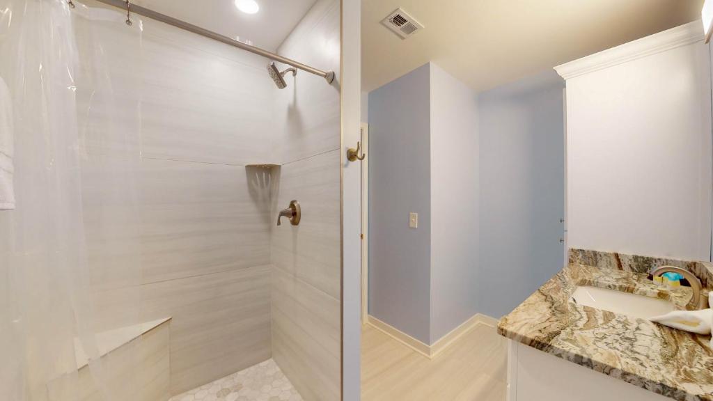a bathroom with a shower and a sink at ALWAYS TURTLE CRAWL home in Jekyll Island