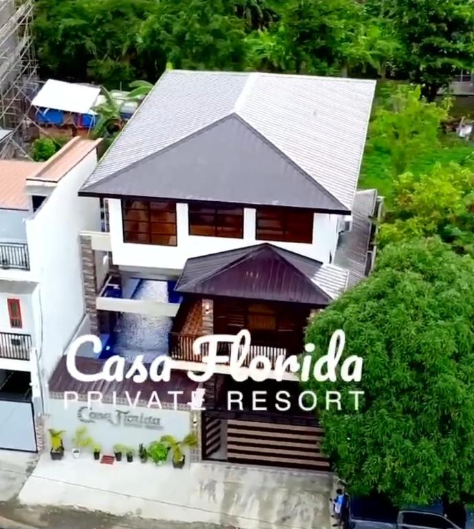 a house with a sign for a resort at Casa Florida Private Resort - Calamba in Calamba