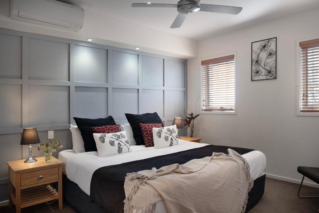 a bedroom with a large bed with pillows on it at Villa Sorelle in the heart of Daylesford in Daylesford