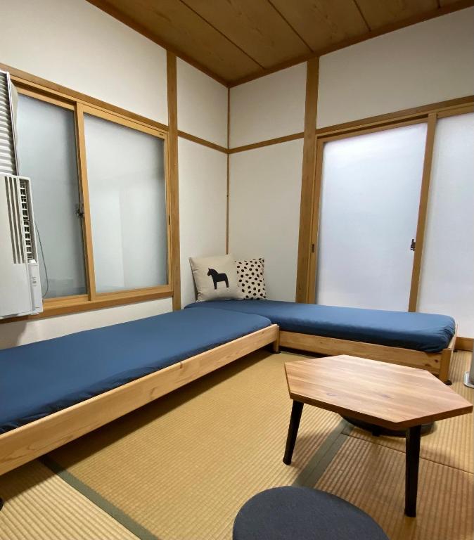 Postel nebo postele na pokoji v ubytování Kusatsu KOTODAMA