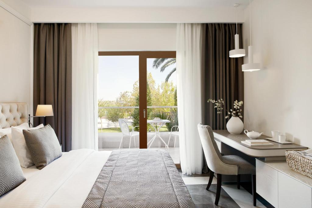 A bed or beds in a room at Potidea Palace Hotel