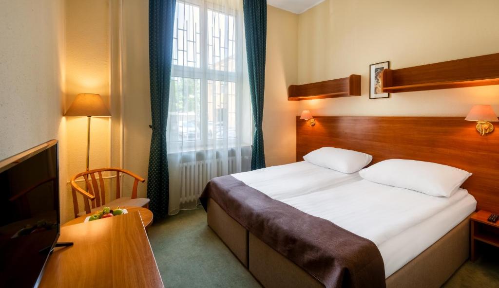 Posteľ alebo postele v izbe v ubytovaní Hotel Millennium