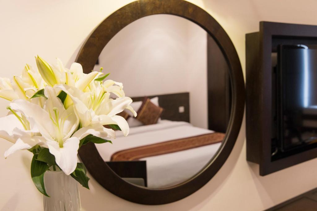 Giường trong phòng chung tại Edele Hotel Nha Trang Beach