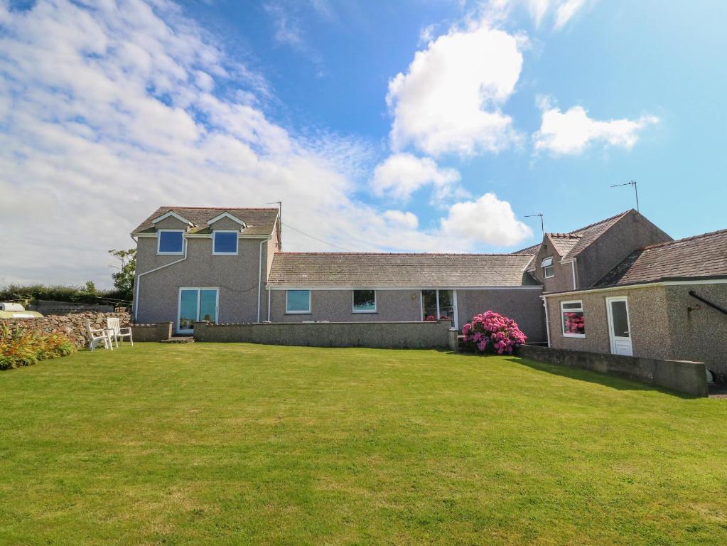 a house with a large yard in front of it at Gwynlys in Holyhead