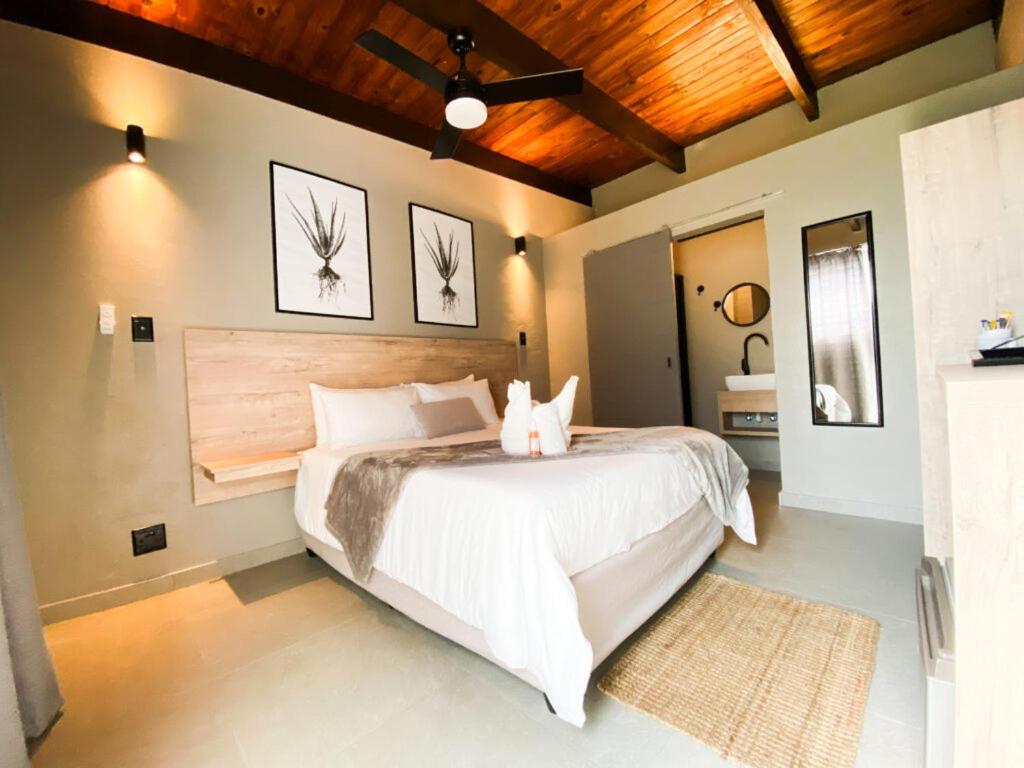 a bedroom with a large white bed in a room at The Mole Guesthouse in Swakopmund
