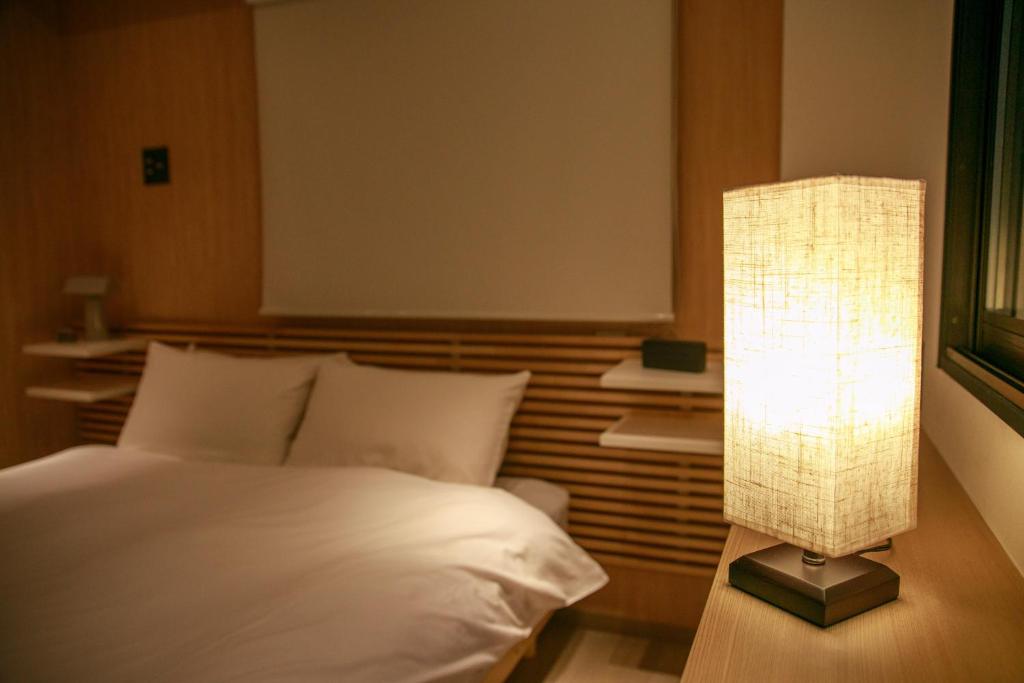 Postel nebo postele na pokoji v ubytování MKG Home・芝