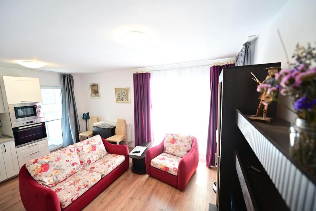 a living room with a couch and a chair at FLH - Apartament Kathy Sibiu in Turnişor