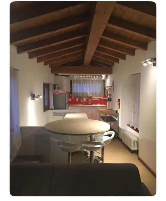 a kitchen and a table and chairs in a room at Appartamento in Centro Storico - Boutique in Clusone