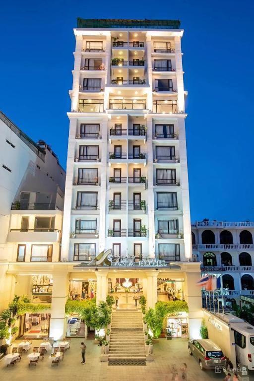 a tall white building with stairs in front of it at Asia Hotel Hue in Hue