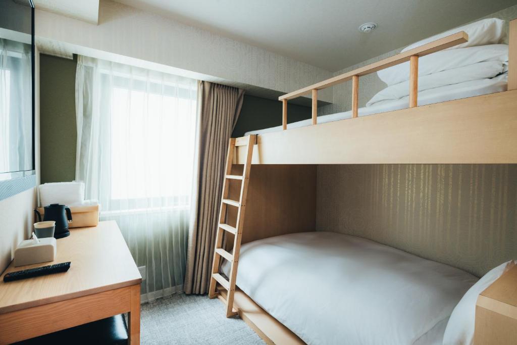 Postel nebo postele na pokoji v ubytování MEANDER Osaka