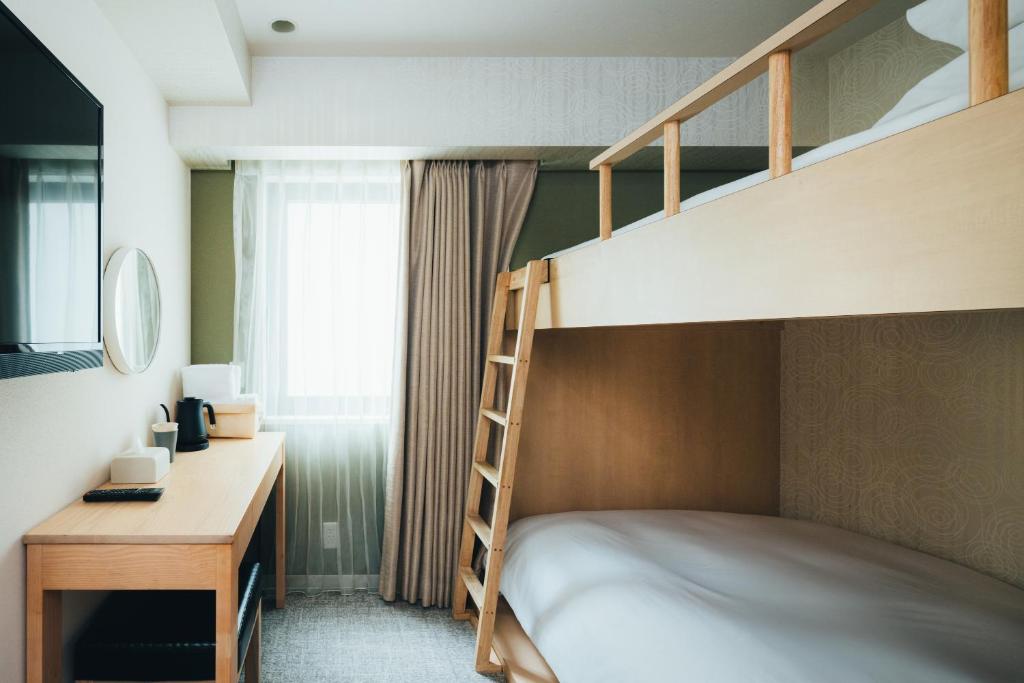 Postel nebo postele na pokoji v ubytování MEANDER Osaka