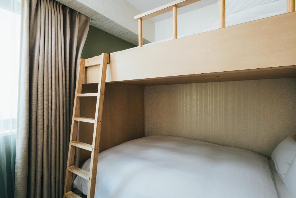 Postel nebo postele na pokoji v ubytování MEANDER Osaka