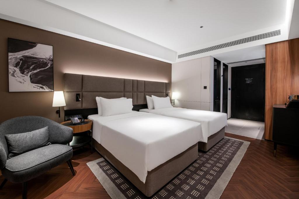 Postel nebo postele na pokoji v ubytování IntercityHotel Xi'an Dayan Pagoda by DH