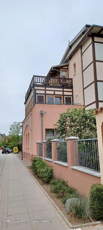 a large pink building on the side of a street at Residenz Seestern Ws 08 in Kühlungsborn