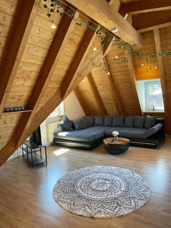 a living room with a black couch in a attic at Apartment am Ronhof in Fürth