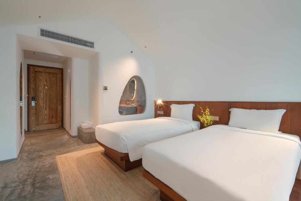 Postel nebo postele na pokoji v ubytování Green World Hotel Nha Trang