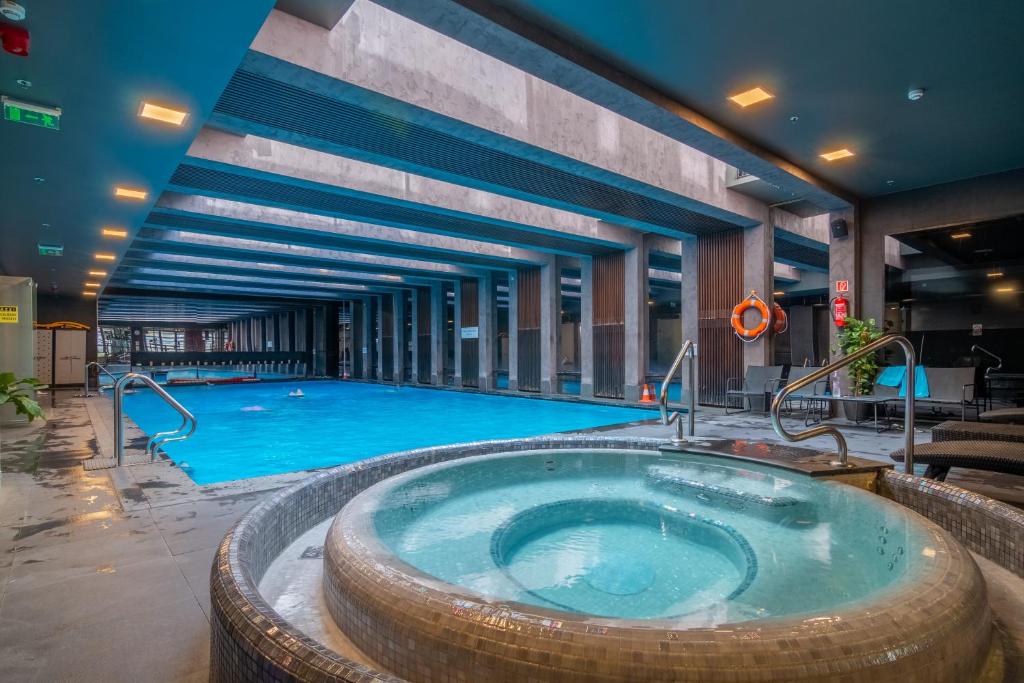 a large pool with a large tub in a building at SWU Opera in Budapest