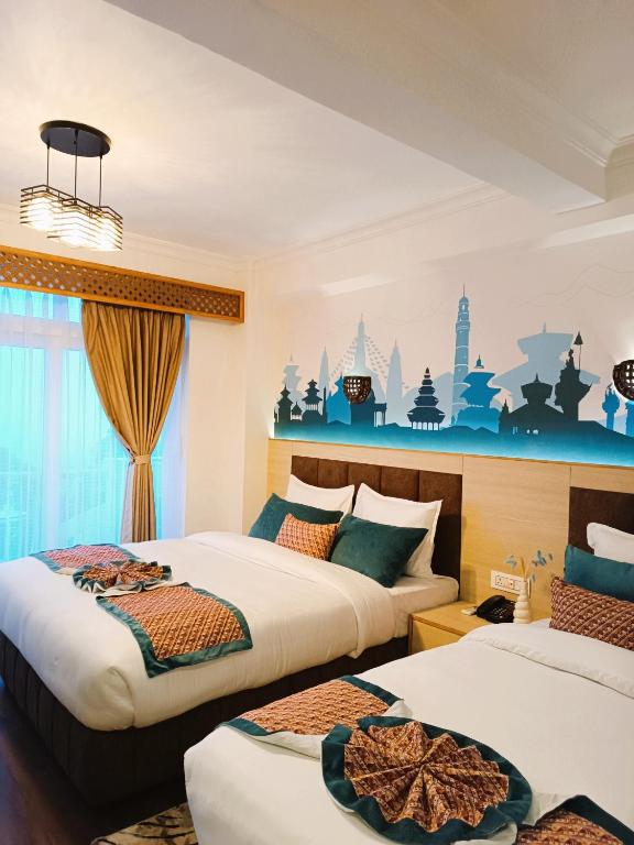 a hotel room with two beds and a mural on the wall at Mountain Vista Retreat - Nagarkot in Nagarkot