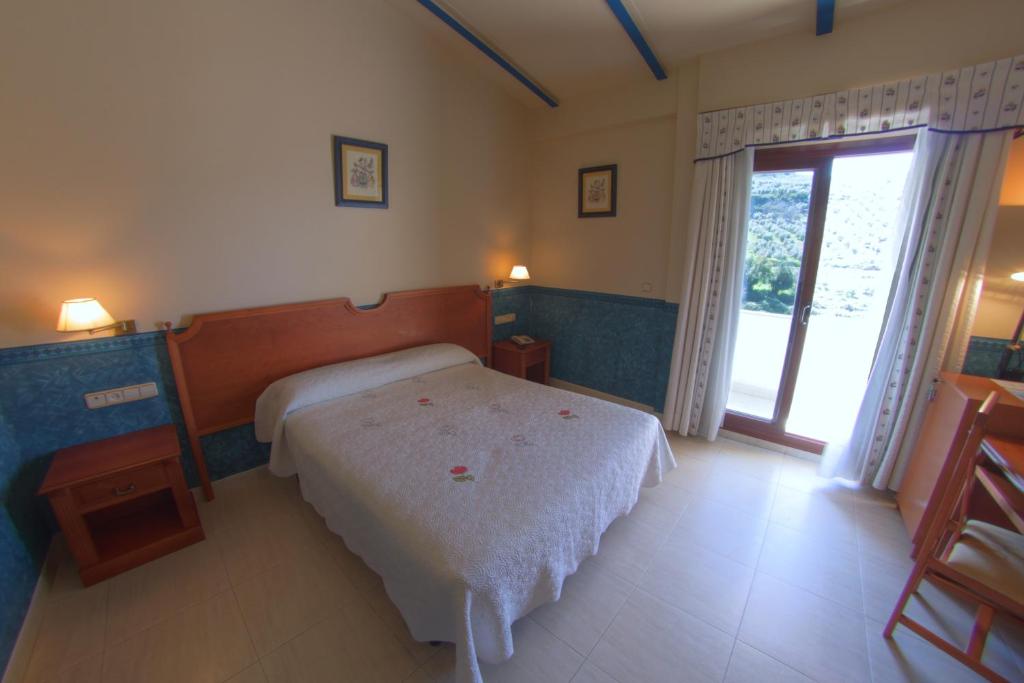 Postel nebo postele na pokoji v ubytování Hotel Avenida