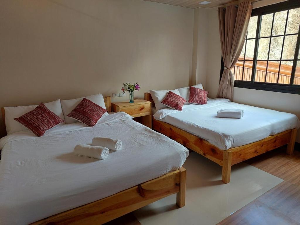 Postel nebo postele na pokoji v ubytování Quarry Bay Hometel Sagada