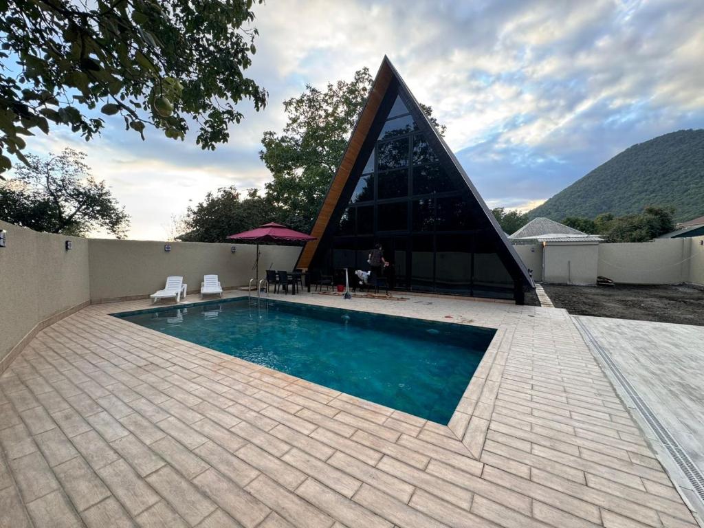 a swimming pool in front of a building at Aframe Park Qebele in Gabala
