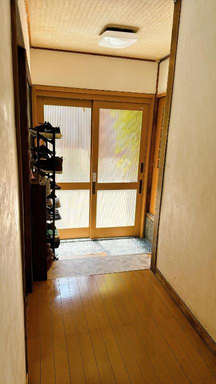 an empty room with a large door and a room with at Ryokan Nakadaya in Tokyo