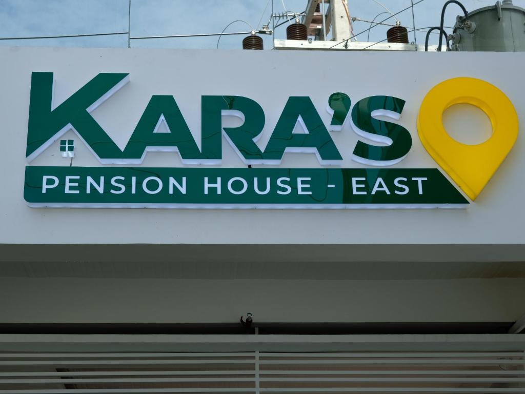 a sign for a penninson house east on a building at Karas Pension House East in Tuguegarao City