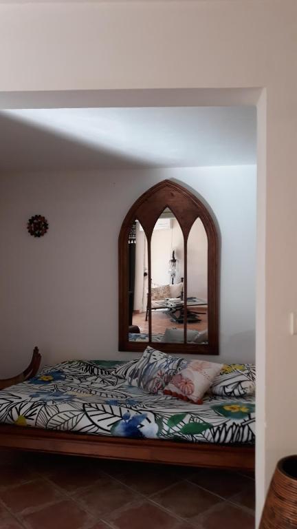 - une chambre avec un lit et un miroir dans l'établissement La TAMARISSIME, à La Seyne-sur-Mer