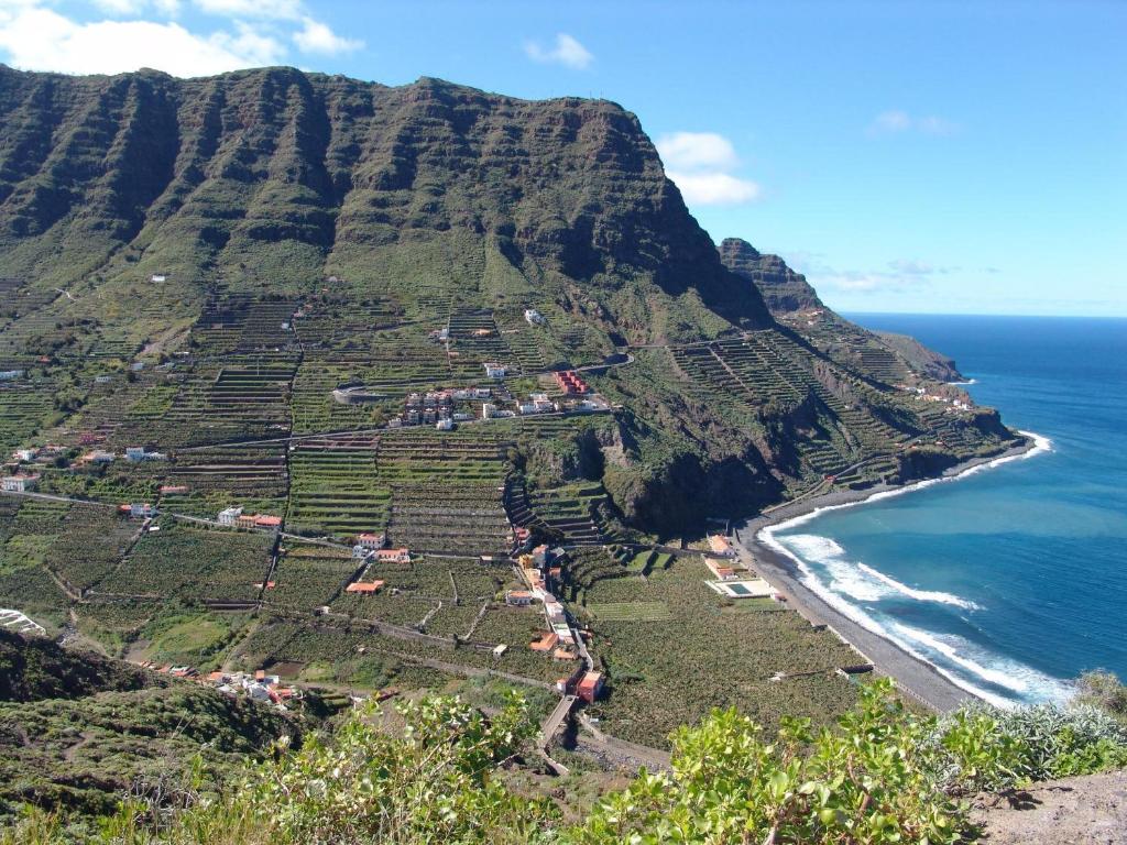 an aerial view of a mountain next to the ocean at Casa Rural La Cuadra in Hermigua
