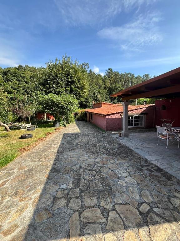 a stone walkway next to a building with a patio at Casa Romeo in Brion