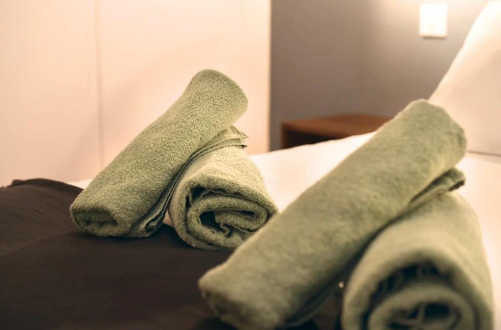 two towels sitting on top of a bed at Le Havre De Paix in Le Perrey