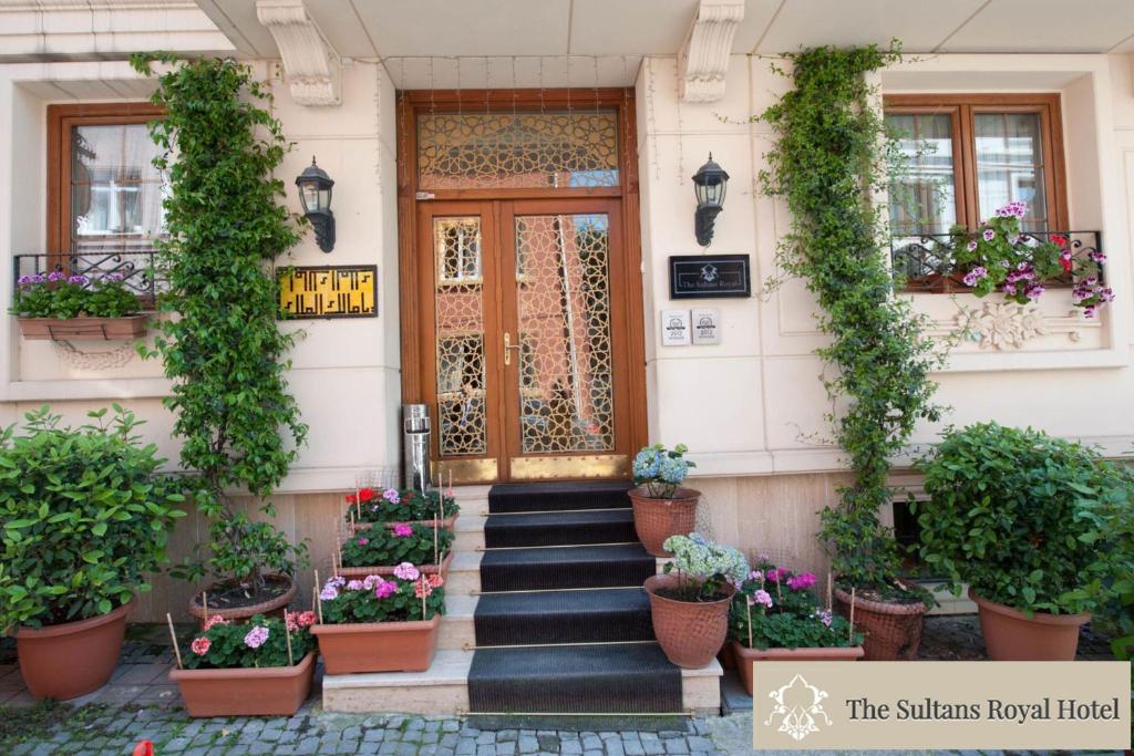 a building with potted plants and a wooden door at Sultans Royal Hotel in Istanbul