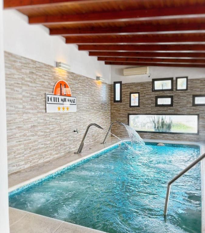 a swimming pool with a fountain in a building at HOTEL MIRAMAR in Miramar