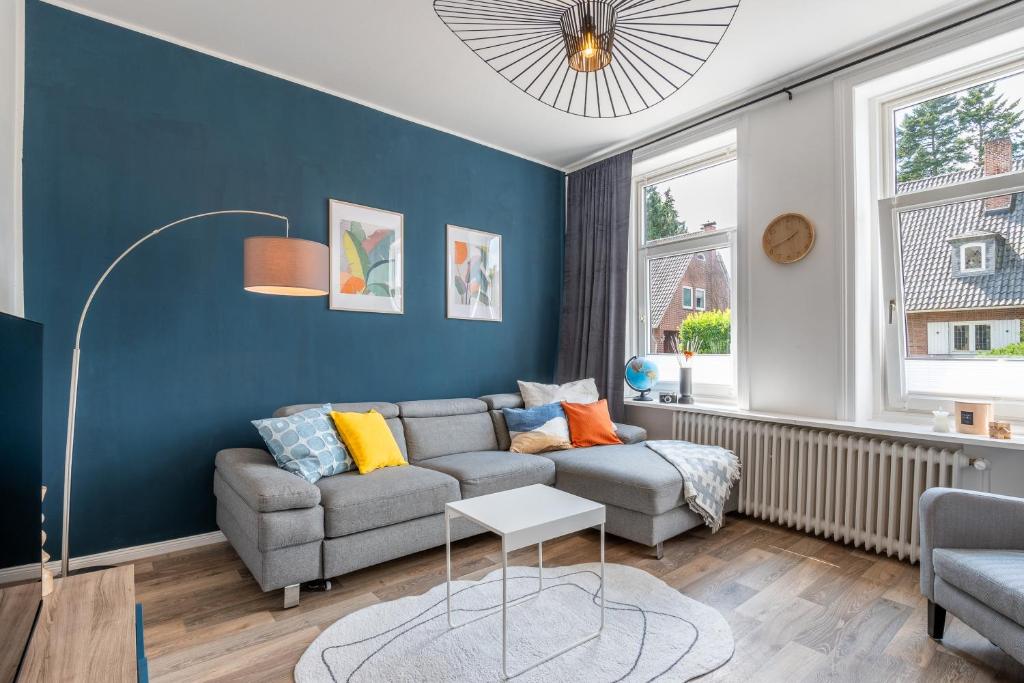 a living room with a couch and a table at 90 RELAX HOMEDESIGN Apartment in Elmshorn bei Hamburg in Elmshorn