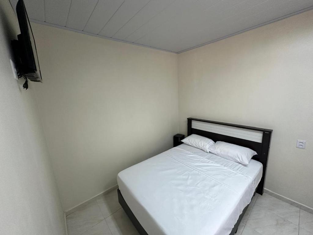 Postel nebo postele na pokoji v ubytování Residencial Aeroconforto - Próximo ao Aeroporto e Fábricas no Tarumã