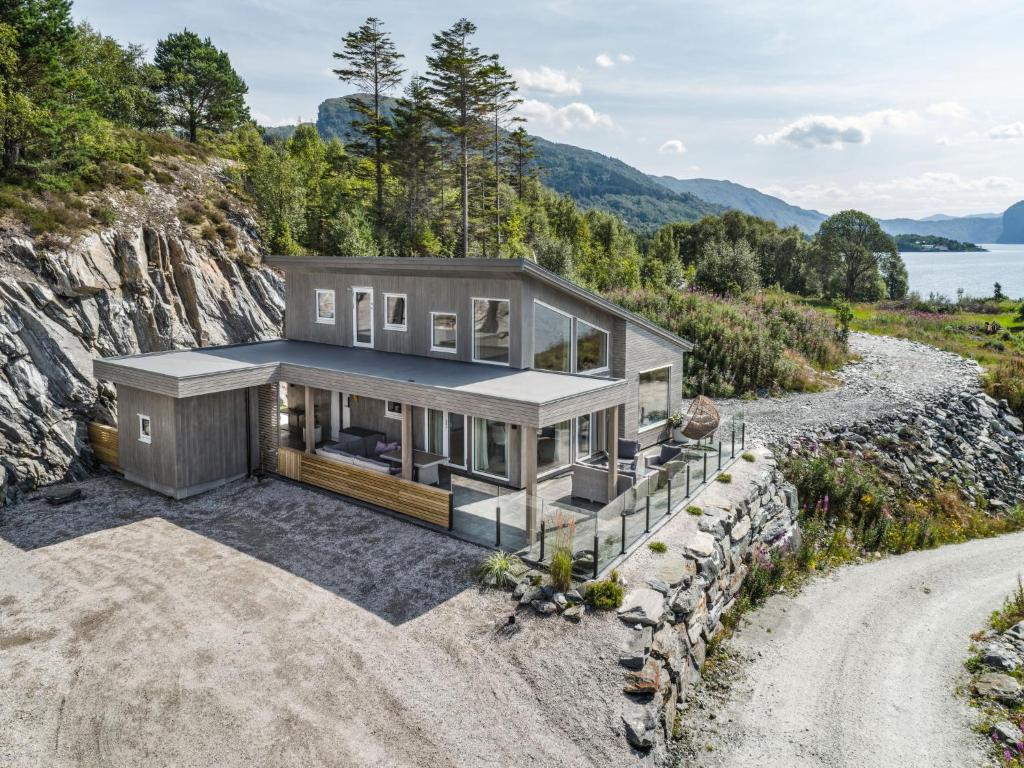 a house on a cliff with a driveway at Holiday Home Hildebu by Interhome in Sørbø