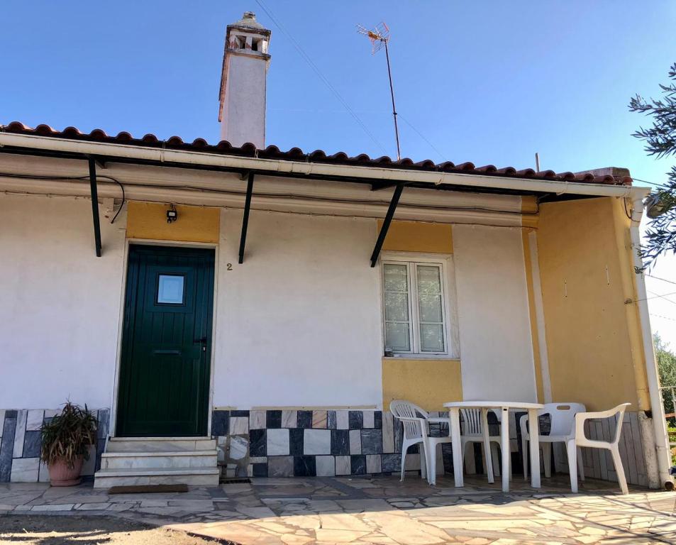 a house with a green door and a table and chairs at Casas da Saibreira - nº2 in Elvas