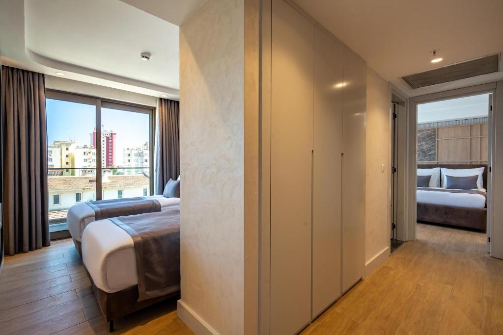 A bed or beds in a room at Awen Lara Hotel