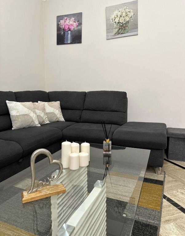 a living room with a black couch and a glass table at Edens house con parcheggio privato in Rapallo