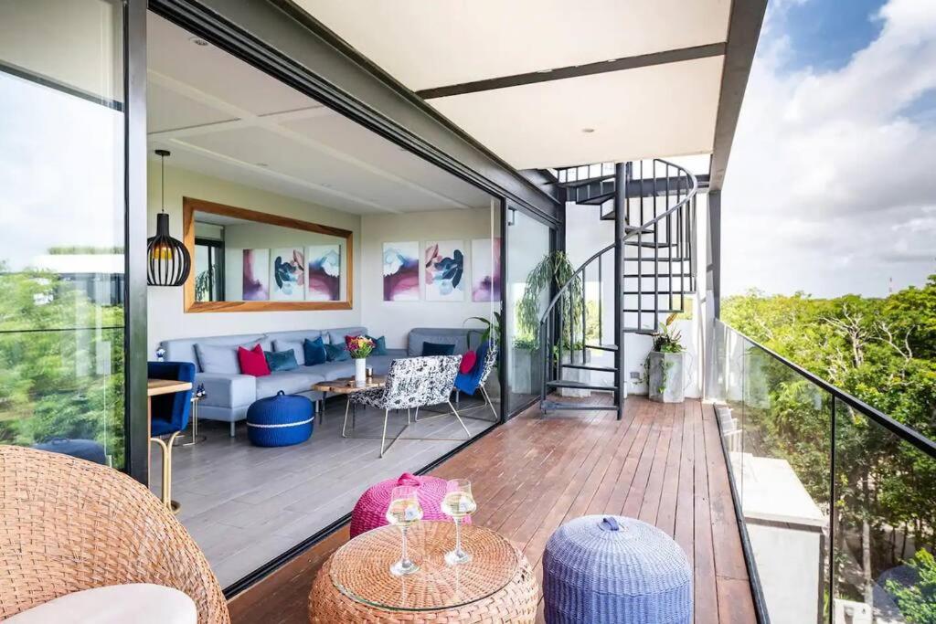 a balcony of a house with a living room at 3BR Penthouse with Rooftop Pool Near Centro in Tulum