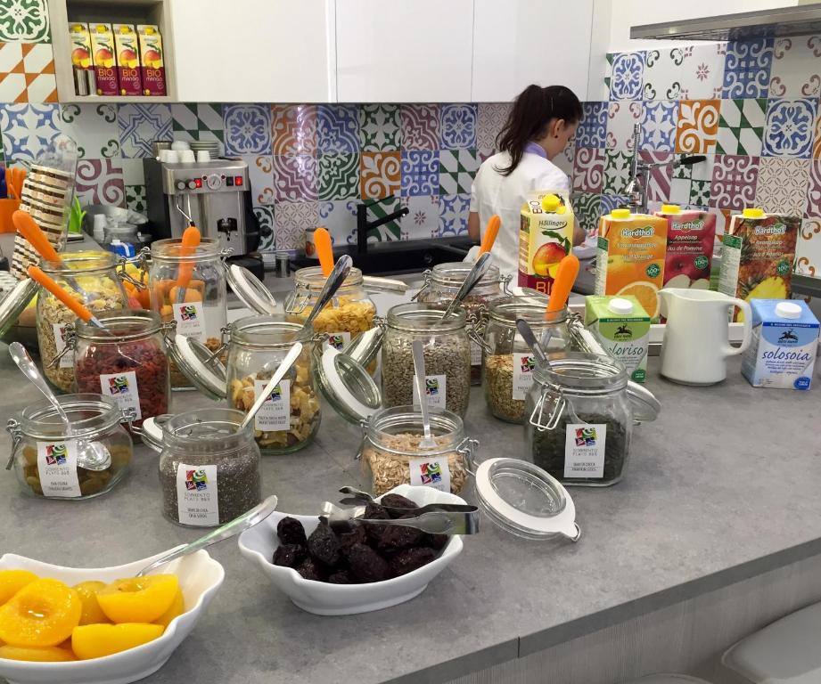 a woman standing in a kitchen with jars of food at Sorrento Flats in Sorrento