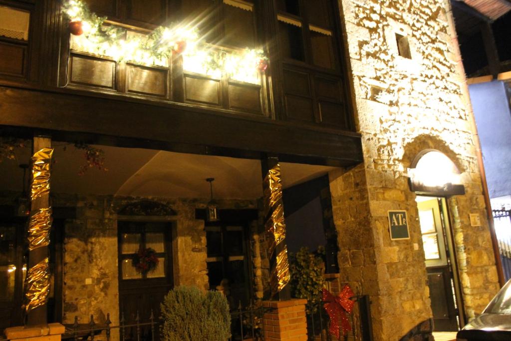 a building with christmas lights on the window at Rodiles Rural Apartamentos in Selorio