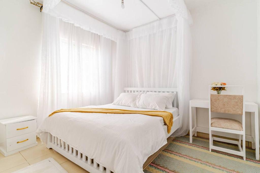 Postel nebo postele na pokoji v ubytování Saruni Homes